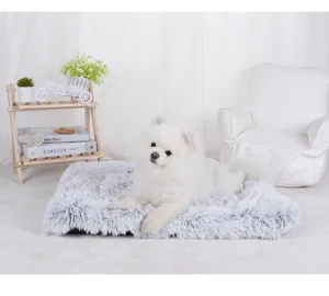 Close-up of fluffy plush gray pet mat with white dog for warm winter deep sleep