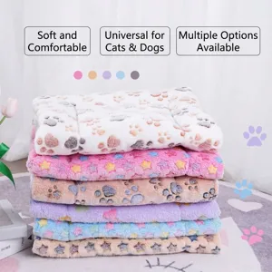 Thick plush pet blankets for cats and dogs stacked in various pastel colors with paw prints