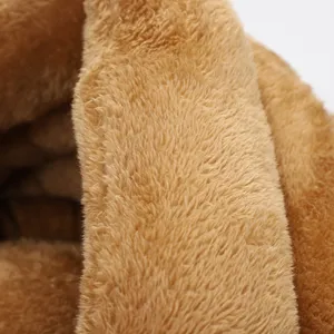 Detailed macro shot of warm brown plush material for soft pet cat dog bed lining