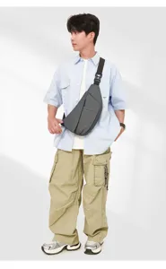 Detail view of grey multi-functional sling chest bag, lightweight anti-theft design for daily travel