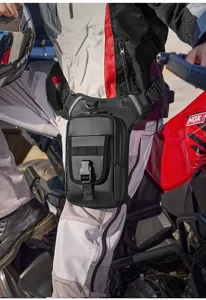Close-up of a waterproof tactical leg bag being worn during a motorcycle ride.
