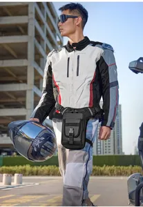 Close-up of a multi-functional black tactical leg bag worn by a motorcyclist outdoors