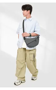 Stylish grey mens crossbody chest bag, multifunctional slim sling daypack for travel.