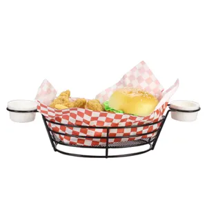 Close-up of black iron wire snack basket with dipping sauce cups and red checkered paper