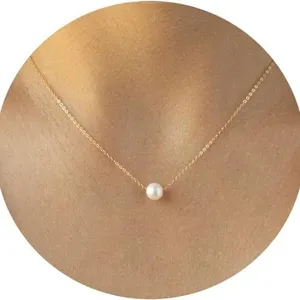 Minimalist gold chain necklace featuring a single white pearl pendant on a neck model