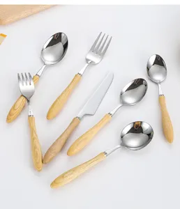 Close-up of 304 stainless steel cutlery set with elegant white ash wood handles