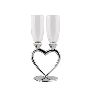 Elegant heart-shaped crystal champagne flutes set with silver base for wedding party