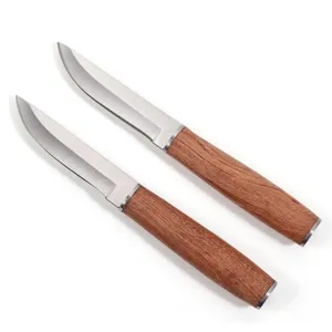 Detail view of two Mongolian meat knives with rosewood handles and curved blades