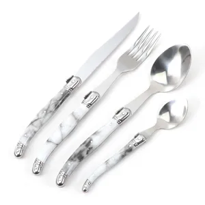 Detail view of stainless steel western cutlery set with elegant marble handles and bee design.