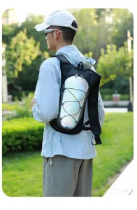 Back view of a person wearing a reflective hydration backpack for outdoor running.