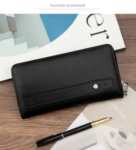 Detail view of men's long wallet with brushed leather texture and hand strap.