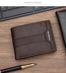 Vintage brown leather bifold men's wallet with MenBense logo displayed on a wooden desk