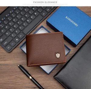 Premium men's brown PU leather bifold wallet presented in a blue gift box on a desk.
