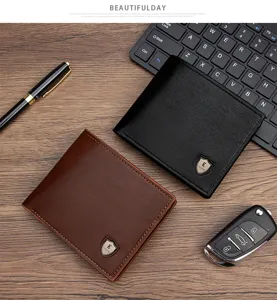 Detail shot of two classic bifold leather wallets for men in black and brown on a wooden desk