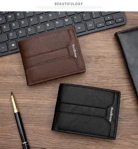 Detailed view of brown and black vintage leather bifold wallets on office desk.