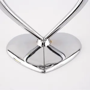 Close-up of silver heart-shaped metallic base of a crystal champagne glass set