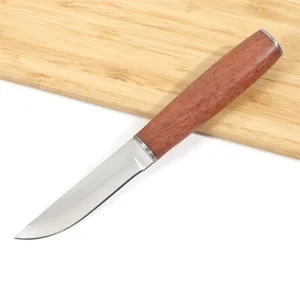 Detail of a Mongolian meat eating knife with a polished rosewood handle on a wood board.