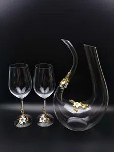 Exquisite enamel flower decorated crystal decanter and red wine goblet set for fine dining.