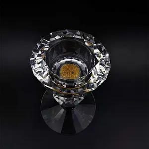 Nahaufnahme eines facettierten Kristallkerzenhalters mit schimmerndem Goldboden.