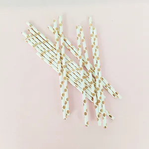Primo piano dettagliato di cannuccie di carta bianche con pois dorati metallizzati