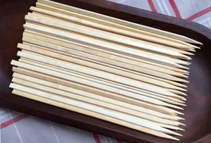 Macro view of high-quality disposable flat bamboo skewers for professional BBQ grilling