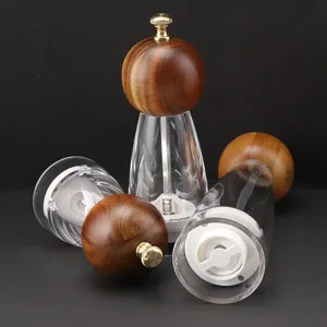 Wooden manual pepper grinder with clear acrylic body and ceramic core for kitchen seasoning.