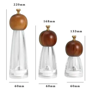 Wooden and acrylic manual pepper grinder set with various size options for kitchen cooking use.