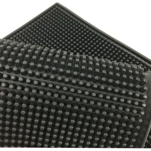Close-up of black non-slip PVC bar mat with thick rubberized drain studs