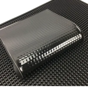 Close-up of black PVC bar mat with non-slip textured surface for barware protection