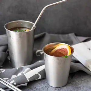 Set of two stainless steel cups with metal straw for cold drinks and juices
