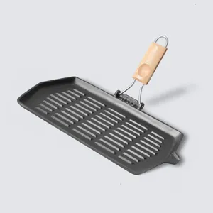 Rectangular cast iron steak grill pan with a folding wooden handle for portable cooking