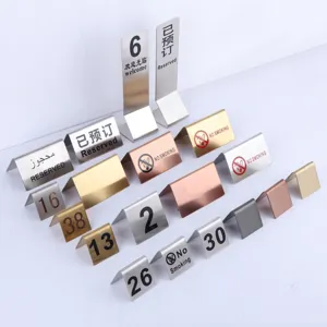 Stainless steel table number signs, metal reserved and no smoking signs for restaurant desks.