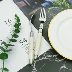 Close-up detail of Laguiole bee series steak forks with ivory white ABS handles