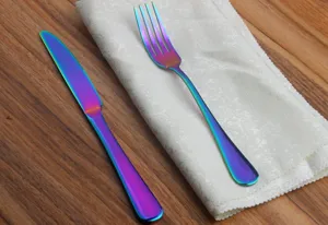 Detailed macro view of rainbow iridescent stainless steel dinner knife and fork set