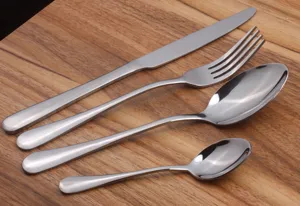 High-quality stainless steel silverware set detail view on wooden surface