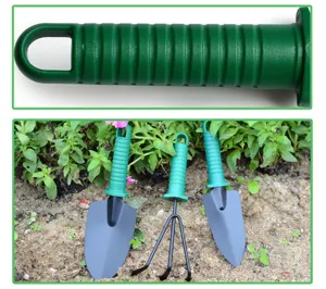 Garden tool set detail showing durable green plastic handle and metal shovel cultivator for planting.