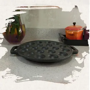 Detail view of 19-hole cast iron takoyaki pan with sturdy double handles