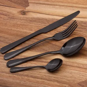Modern 4-piece black stainless steel cutlery set on elegant wooden background
