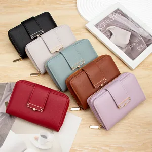 Variety of women's pebbled leather short wallets with floral gold buckle detail
