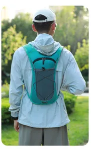 Outdoor turquoise hydration backpack vest for cycling and hiking shown on model back view