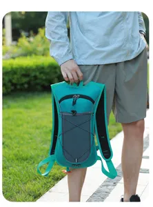 Cyan outdoor hydration backpack for cycling and running, detail of hand holding handle.