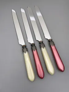 Macro detail of stainless steel cake knives featuring elegant vintage decorative handles