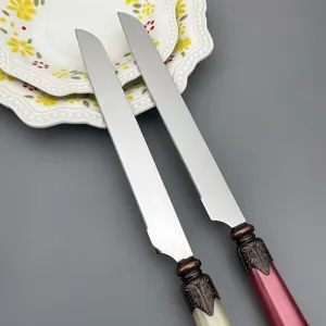 Detailed view of serrated stainless steel cake knives featuring elegant vintage decorative handles