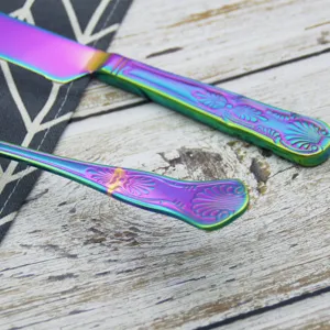 Detailed view of rainbow iridescent stainless steel cake server handle with vintage pattern.