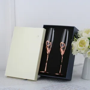 Exquisite rose gold heart-shaped champagne flutes set presented in a luxury navy gift box