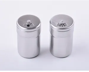 Detailed view of two stainless steel spice shakers with rotating adjustable lids