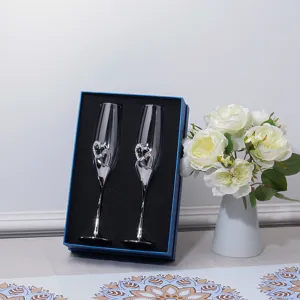 Elegant heart-shaped crystal champagne flutes set in a premium blue gift box for wedding gift