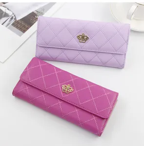 Close-up view of elegant quilted long wallets for women with golden crown emblem