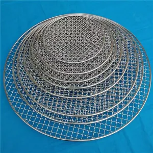 Stacked round stainless steel BBQ grill mesh nets in various sizes on blue background