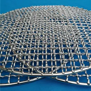 Close-up view of circular stainless steel grill grate featuring a durable woven mesh